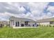 Expansive backyard features a stone patio with fire pit, dining set, grill, privacy fence, and lush green lawn at 4309 Viva Ln, Indianapolis, IN 46239