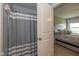 Bathroom featuring a shower with a striped curtain and view into the bedroom at 4309 Viva Ln, Indianapolis, IN 46239