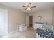 Bedroom with carpet, crib, toy box, dresser, sea and dinosaur themed decorations at 4309 Viva Ln, Indianapolis, IN 46239