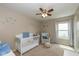 Bedroom with carpet, crib, chair, sea themed decorations and natural light at 4309 Viva Ln, Indianapolis, IN 46239