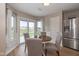 Bright breakfast nook with stainless steel fridge and sliding glass doors to backyard at 4309 Viva Ln, Indianapolis, IN 46239