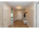 Inviting foyer featuring hardwood floors, neutral paint, and a convenient coat rack at 4309 Viva Ln, Indianapolis, IN 46239