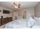 Comfortable main bedroom with ceiling fan, dresser, TV and a decorative wreath at 4309 Viva Ln, Indianapolis, IN 46239