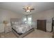 Comfortable main bedroom with carpet, side table, dresser, and natural light at 4309 Viva Ln, Indianapolis, IN 46239