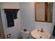 Cozy bathroom with white tiled backsplash, decorative mirror, and towel rack at 4718 W Troy Ave, Indianapolis, IN 46241