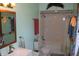 A full bathroom features a shower-tub combo, toilet, vanity and mirror at 4718 W Troy Ave, Indianapolis, IN 46241