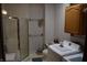 Bathroom and laundry room featuring a shower, single vanity, toilet, and washer and dryer at 4718 W Troy Ave, Indianapolis, IN 46241
