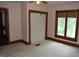 Neutral bedroom featuring carpet, trim, a window, and a closet at 4718 W Troy Ave, Indianapolis, IN 46241