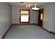 Empty bedroom featuring carpet flooring, window, closet, and vintage wood trim at 4718 W Troy Ave, Indianapolis, IN 46241