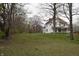 Two-story home with large lawn and surrounded by trees and greenery offering a serene outdoor space at 4718 W Troy Ave, Indianapolis, IN 46241