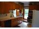 Functional kitchen featuring wooden cabinets, white countertops, and modern appliances offering efficiency and style at 4718 W Troy Ave, Indianapolis, IN 46241