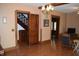 An open living room with hardwood floors, staircase access, and views into adjacent rooms at 4718 W Troy Ave, Indianapolis, IN 46241