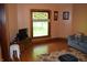 Comfortable living room featuring a large window, hardwood floors, and a comfortable sofa at 4718 W Troy Ave, Indianapolis, IN 46241