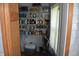 Walk-in pantry with shelving stocked with food storage containers, jars, canned goods, and other kitchen items at 4718 W Troy Ave, Indianapolis, IN 46241
