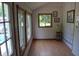 Bright sunroom with natural light, complemented by wood-framed windows and cozy decor offers a peaceful retreat at 4718 W Troy Ave, Indianapolis, IN 46241