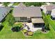 An aerial view showcases a backyard featuring a patio, gazebo, mature trees and a landscaped yard at 5047 Skipping Stone Dr, Indianapolis, IN 46237