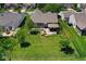 Aerial view of a home showcasing the backyard, patio, landscaping, and neighborhood at 5047 Skipping Stone Dr, Indianapolis, IN 46237