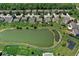 Neighborhood aerial view of pond showcasing homes with well-maintained yards, mature trees, and landscaping at 5047 Skipping Stone Dr, Indianapolis, IN 46237