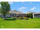 Backyard featuring a covered patio area and lush landscaping, great for outdoor entertaining and relaxation at 5047 Skipping Stone Dr, Indianapolis, IN 46237