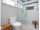 Modern bathroom features a glass shower, subway tile, and a small wooden bench inside at 5047 Skipping Stone Dr, Indianapolis, IN 46237