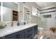 Stylish bathroom with a double vanity, tiled shower, and modern fixtures at 5047 Skipping Stone Dr, Indianapolis, IN 46237