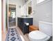 Modern bathroom with a double vanity, wood-look floors, and a toilet at 5047 Skipping Stone Dr, Indianapolis, IN 46237