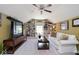 The finished bonus room features built-in bookshelves and cabinets, a ceiling fan, and comfortable seating at 5047 Skipping Stone Dr, Indianapolis, IN 46237