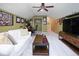 Finished bonus room featuring vaulted ceilings, ceiling fan, comfortable seating, and a dedicated desk space at 5047 Skipping Stone Dr, Indianapolis, IN 46237