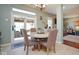 Well-lit dining area with a round table, comfortable seating, and a view of the backyard patio at 5047 Skipping Stone Dr, Indianapolis, IN 46237