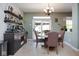 Bright dining area with a stylish bar, modern lighting, and access to the outdoor patio at 5047 Skipping Stone Dr, Indianapolis, IN 46237