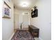 Inviting entryway with neutral walls, a decorative rug, and a stylish bench and shelf at 5047 Skipping Stone Dr, Indianapolis, IN 46237