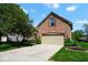 Home with a well-maintained lawn, mature trees, an attached two-car garage, and a brick facade at 5047 Skipping Stone Dr, Indianapolis, IN 46237