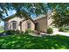 Charming home featuring a well-manicured front yard with lush green grass and beautiful landscaping at 5047 Skipping Stone Dr, Indianapolis, IN 46237