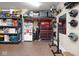 The garage features a refrigerator, tool chests, and shelving units, creating a functional and organized workspace at 5047 Skipping Stone Dr, Indianapolis, IN 46237