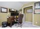 Home office space with dark wood desk and filing cabinets with natural light, perfect for remote work or study at 5047 Skipping Stone Dr, Indianapolis, IN 46237