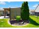Beautifully landscaped yard featuring mature trees, manicured lawn, decorative rocks and privacy screen at 5047 Skipping Stone Dr, Indianapolis, IN 46237