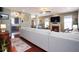 Open-concept living room with hardwood floors, a fireplace, and a view into the kitchen at 5047 Skipping Stone Dr, Indianapolis, IN 46237