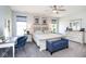 Spacious main bedroom suite featuring a sitting area, large windows, and a ceiling fan at 5047 Skipping Stone Dr, Indianapolis, IN 46237