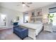 Serene bedroom with a blue bench, side tables, and a vanity area at 5047 Skipping Stone Dr, Indianapolis, IN 46237