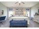 Bright bedroom featuring neutral walls, a ceiling fan, and a cozy seating area at 5047 Skipping Stone Dr, Indianapolis, IN 46237