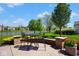 Inviting stone patio with outdoor dining set and a view of the lake and lush landscaping at 5047 Skipping Stone Dr, Indianapolis, IN 46237