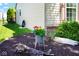 Beautifully landscaped side yard with lush greenery, mulch, and colorful flowers adding charm at 5047 Skipping Stone Dr, Indianapolis, IN 46237