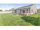 A well-manicured backyard featuring green lawn and patio seating, perfect for outdoor relaxation and entertaining at 5622 Hare Dr, Noblesville, IN 46062