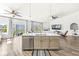 Stylish kitchen island with a sink, seating, and a dishwasher, seamlessly connecting to the living area and backyard views at 5622 Hare Dr, Noblesville, IN 46062
