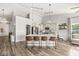 Bright kitchen featuring a large island with seating, stainless steel appliances, and modern lighting fixtures at 5622 Hare Dr, Noblesville, IN 46062