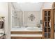 Bright bathroom with a glass shower and soaking tub with decorative wall art and plenty of light at 5948 Ridge Hill Way, Avon, IN 46123