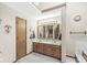 Bathroom featuring double sink vanity with wood cabinets and a large mirror at 5948 Ridge Hill Way, Avon, IN 46123