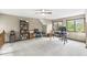 Bright bonus room with two large windows, a ceiling fan, and built in bookcase for a home office at 5948 Ridge Hill Way, Avon, IN 46123