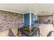 Spacious covered patio featuring a brick accent wall and outdoor dining setup at 5948 Ridge Hill Way, Avon, IN 46123