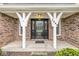 Charming brick home entrance with decorative pillars and modern black front door at 5948 Ridge Hill Way, Avon, IN 46123